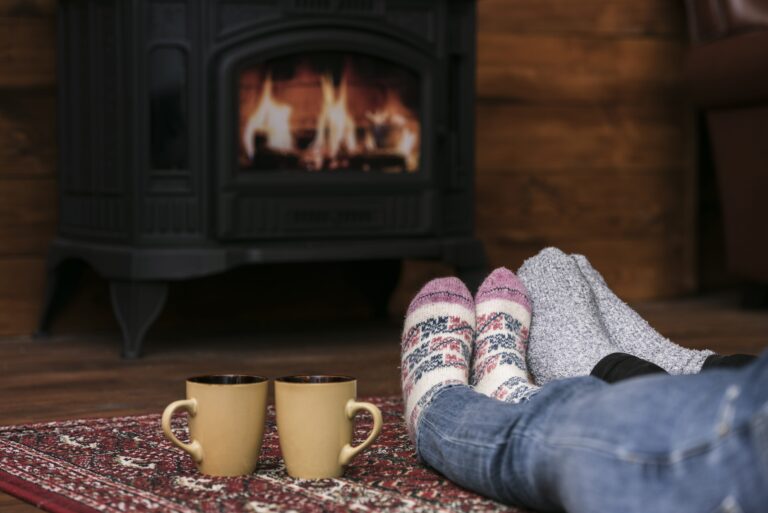 couples-warming-feet-fireplace-min